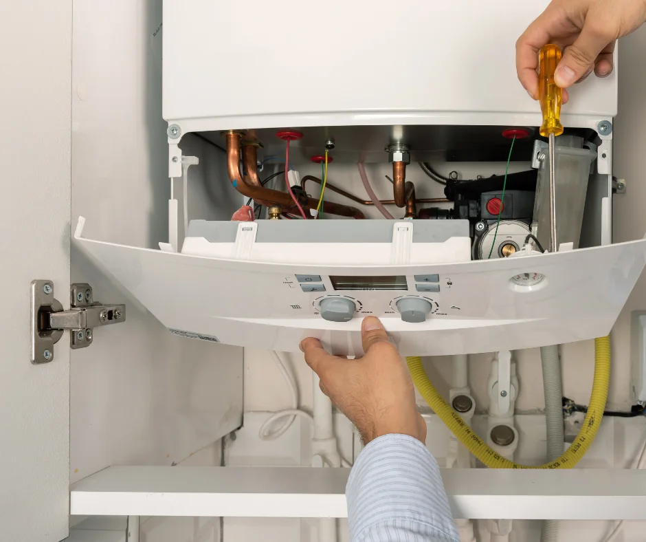 Close-up of a wall-mounted boiler being serviced
